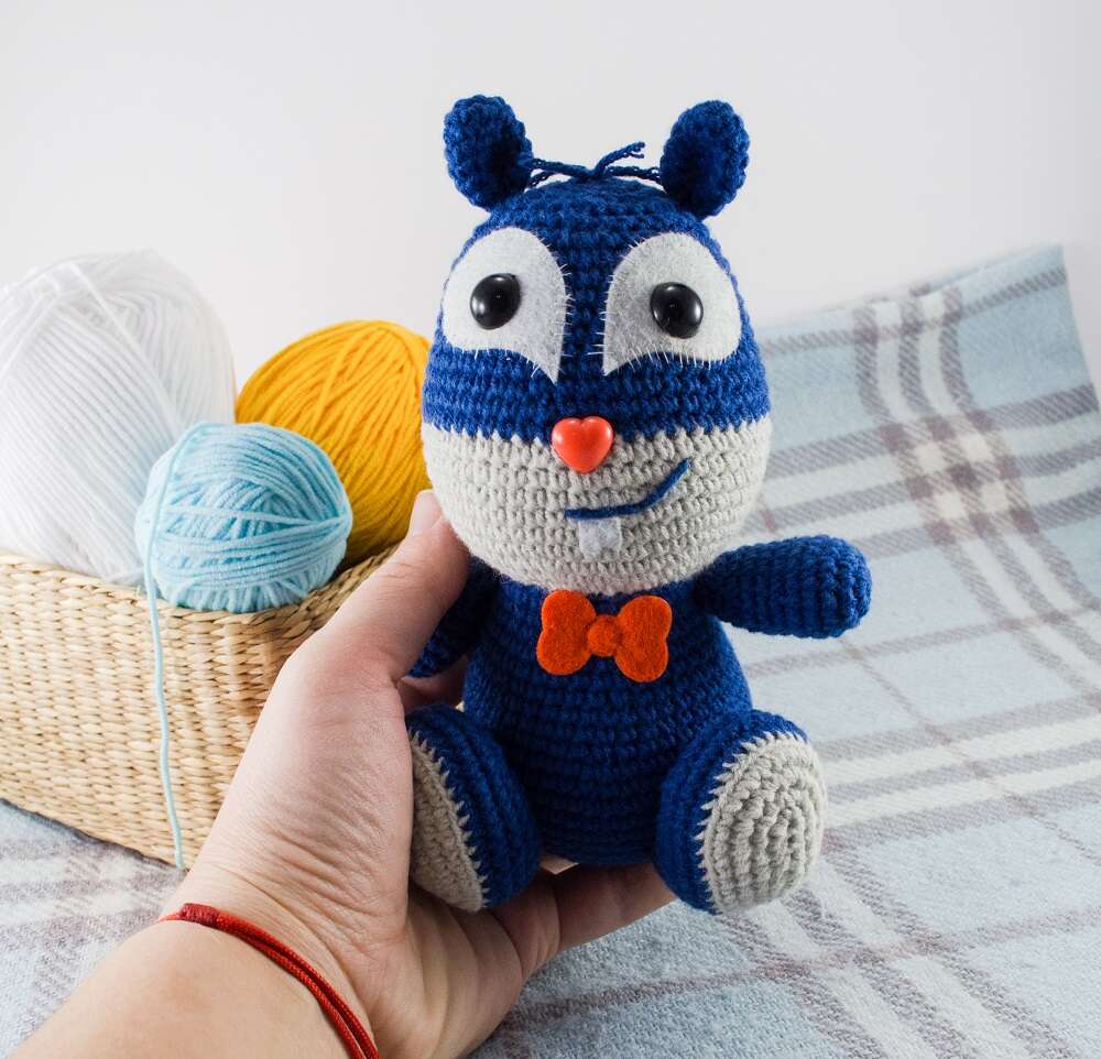 holding in hand crochet squirrel toy