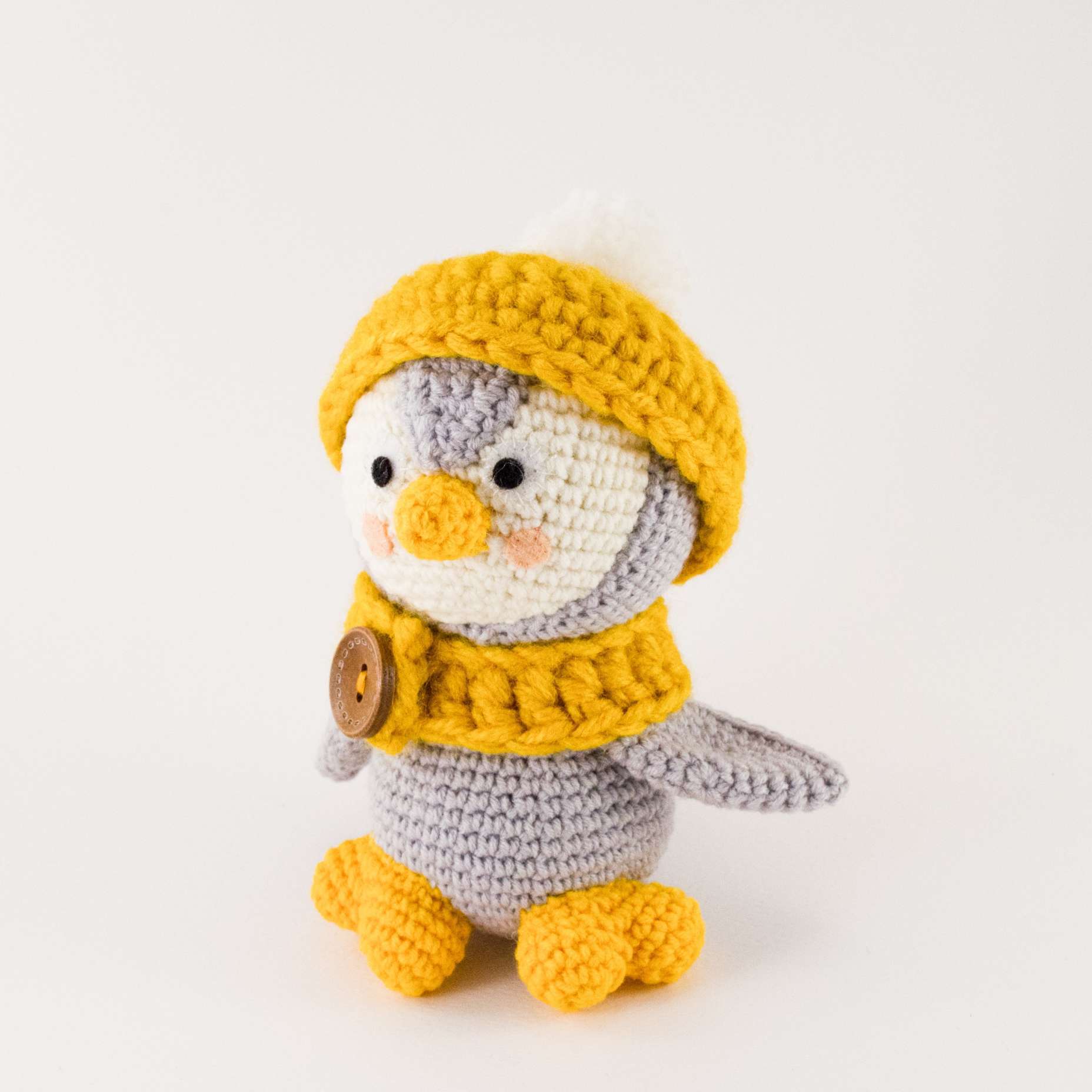 grey penguin with hat and scarf